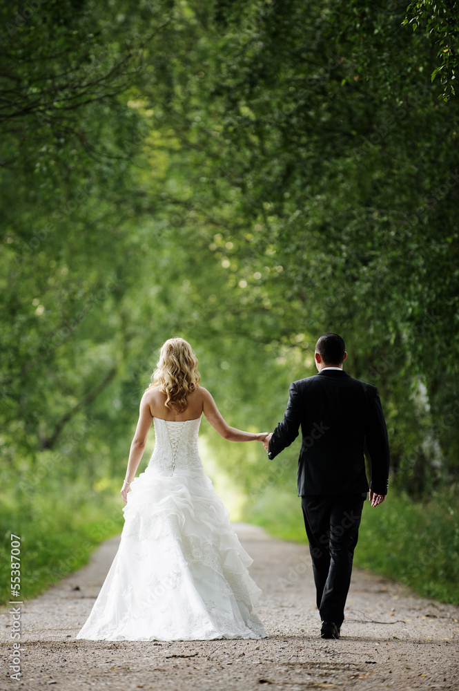 The beautiful happy couple is walking about the marriage ceremon The beautiful happy couple is walking about the marriage ceremon