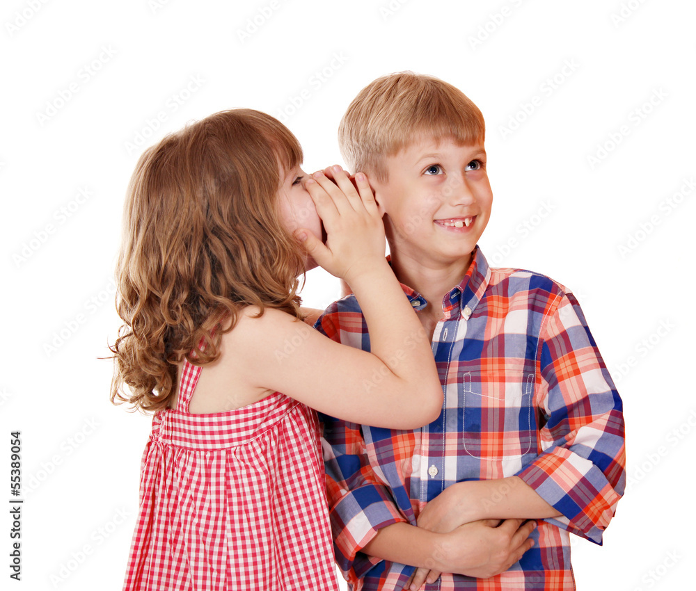 little girl whispers a secret to the boy little girl whispers a secret to the boy