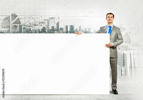 Businessman with blank banner © Sergey Nivens