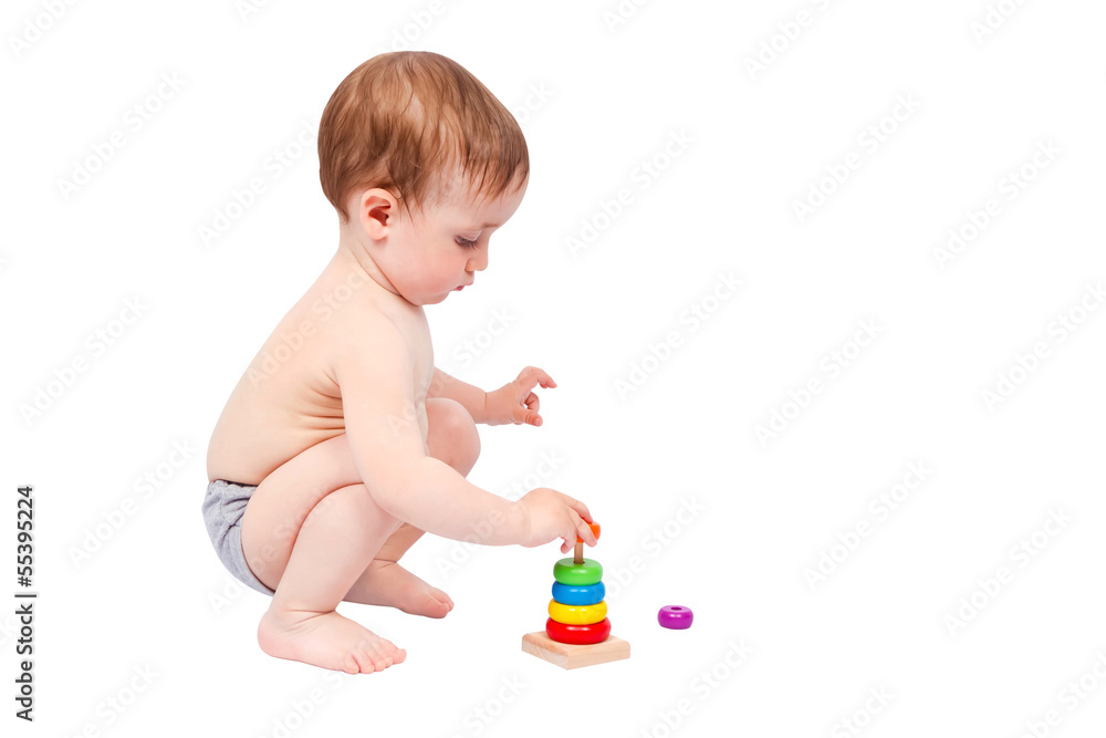 Little boy playing with colorful pyramid Little boy playing with colorful pyramid