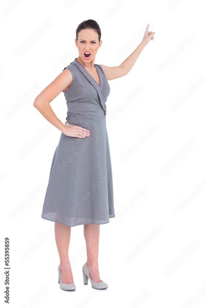 Angry gorgeous woman in classy dress pointing finger up Angry gorgeous woman in classy dress pointing finger up