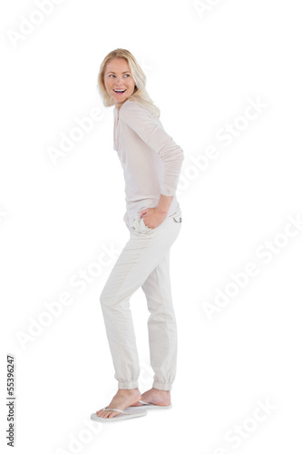 Happy woman with hands in pockets