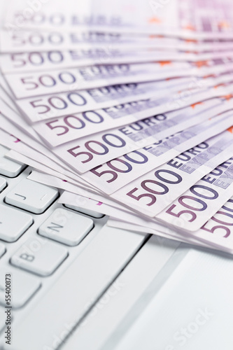Online banking, European paper currency on the computer keyboard