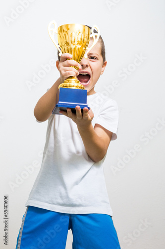 Little boy celebrates his golden trophy
