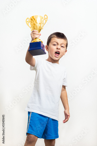 Little boy celebrates his golden trophy