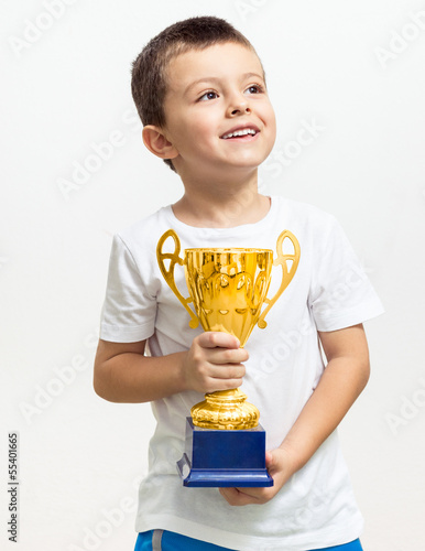 Little boy celebrates his golden trophy