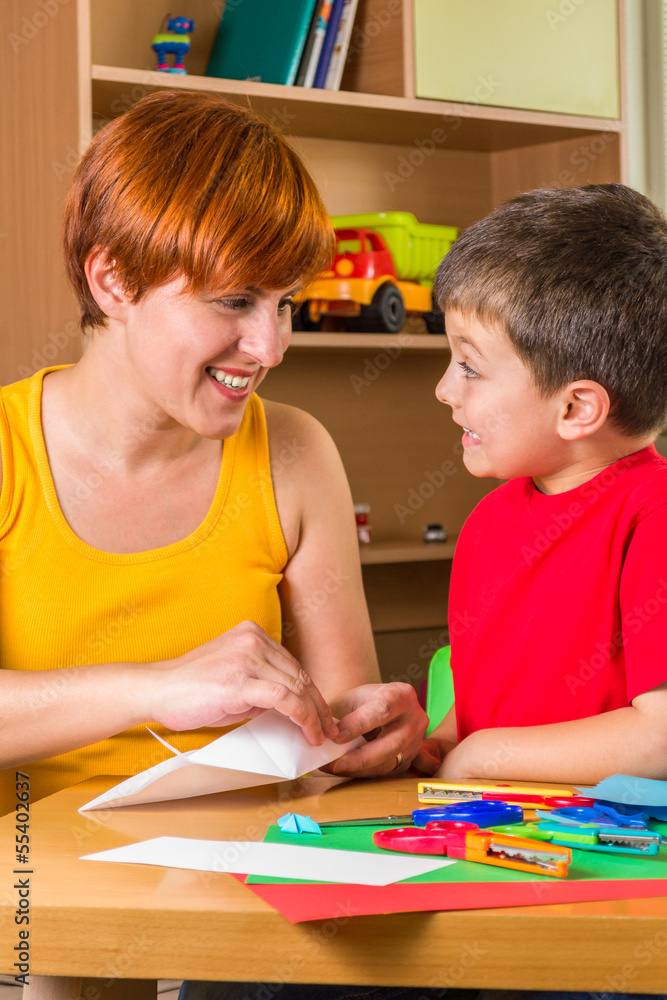 Mother and son playing with paper Mother and son playing with paper