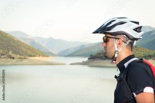 Mountain biker beside a beautiful lake © Nikola Solev