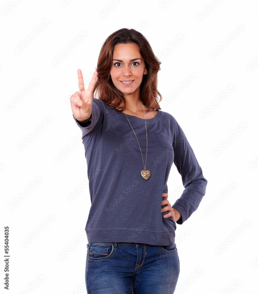 Lovely woman in jeans showing a victory sign Lovely woman in jeans showing a victory sign