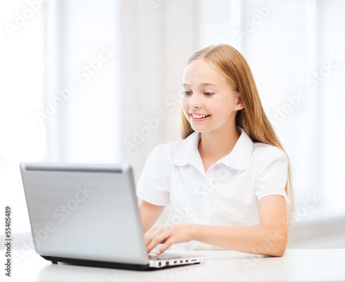 girl with laptop pc at school