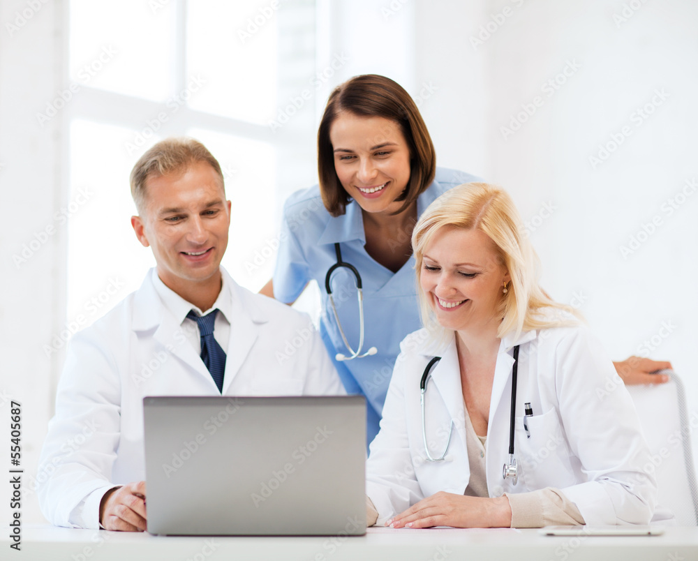 group of doctors looking at tablet pc group of doctors looking at tablet pc
