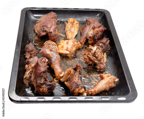 roasted chicken on a baking sheet on a white background