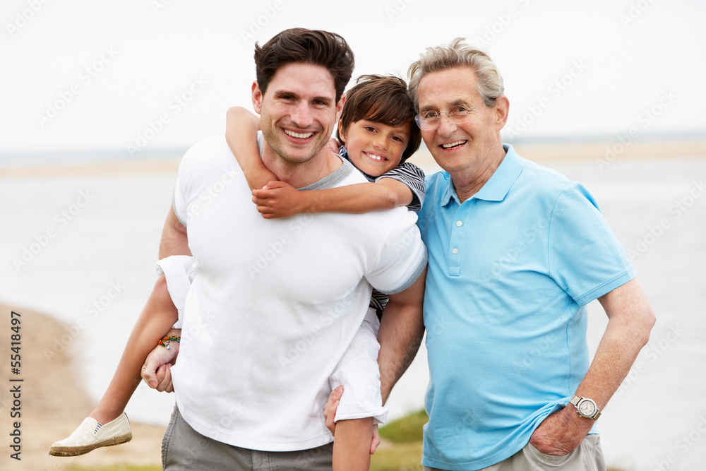 Male Members Of Multi Generation Family Standing By Sea Male Members Of Multi Generation Family Standing By Sea