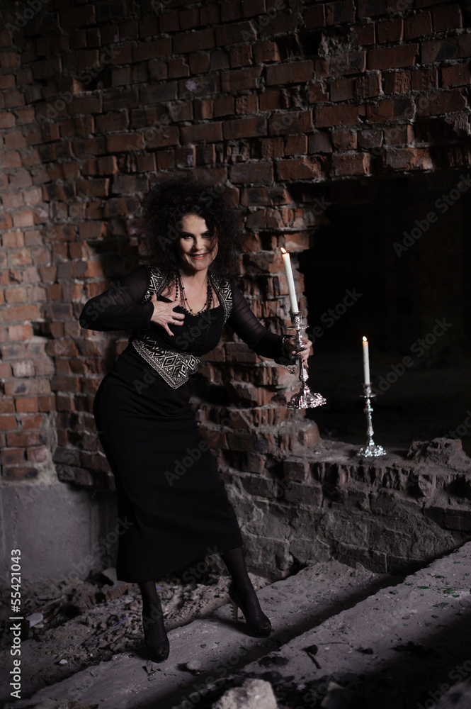 Young sexy witch making the witchcraft in the dungeon