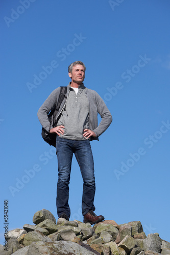 Male Walker Standing On Pile Of Rocks
