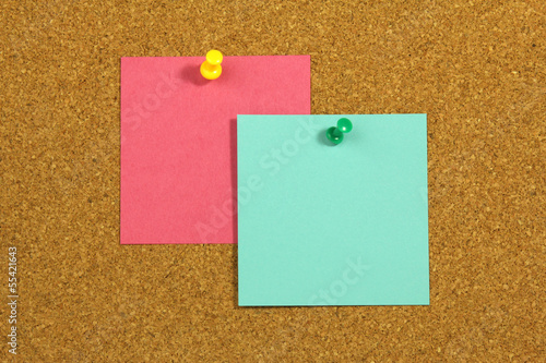 pink and green blank cards on cork board