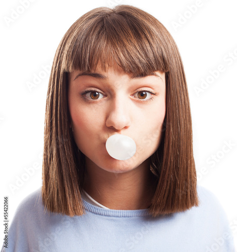girl doing a bubble with a chewing gum on a white background