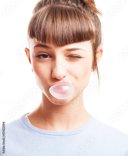 girl doing a bubble with a chewing gum on a white background