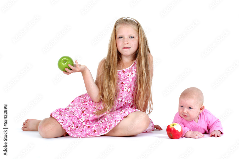 Fototapeta premium adorable little two sisters 8 year and 3 month ols with apple