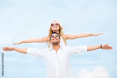 couple holding hands up at sea side