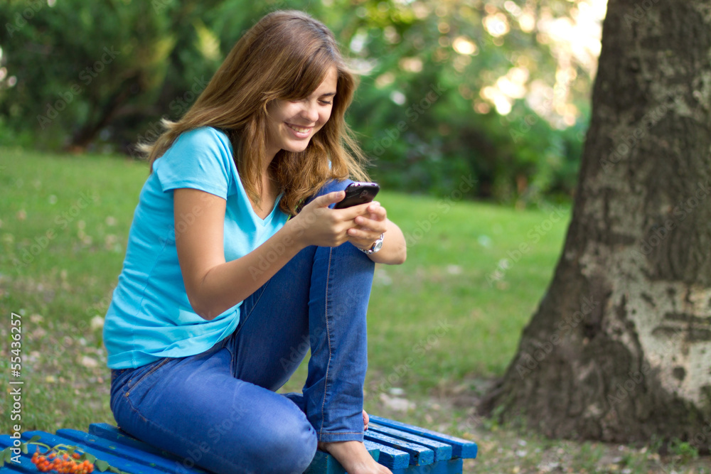 beautiful girl in the park with phone beautiful girl in the park with phone