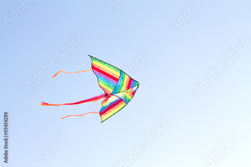 colorful kite flying on background of blue sky