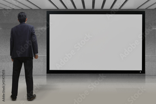 Businessman looking at blank TV screen © Naypong Studio