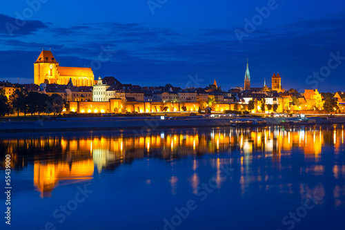 Torun old town at night reflected in the river, Poland