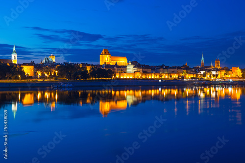 Torun old town at night reflected in the river, Poland