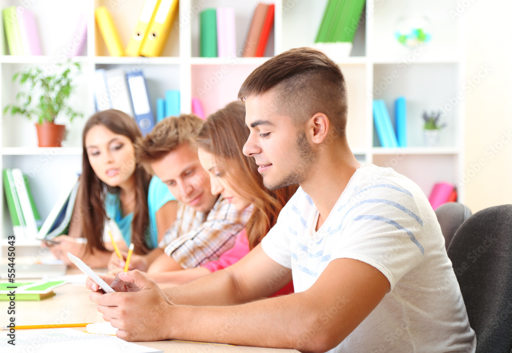 Group of young students sitting at the library Group of young students sitting at the library