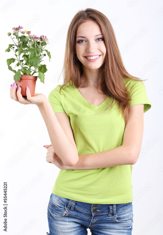 Beautiful girl with flower in pot isolated on white Beautiful girl with flower in pot isolated on white
