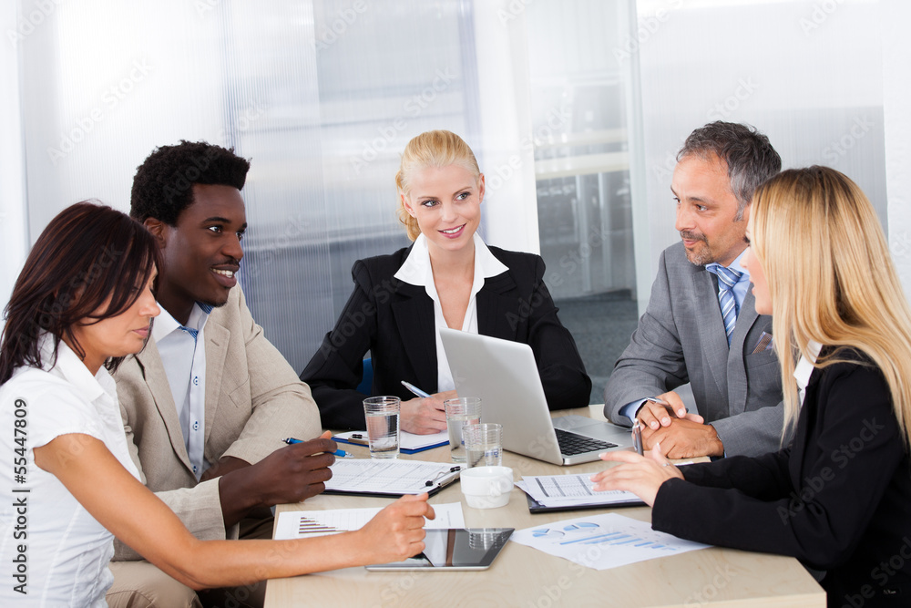 Group Of Businesspeople Discussing Together Group Of Businesspeople Discussing Together