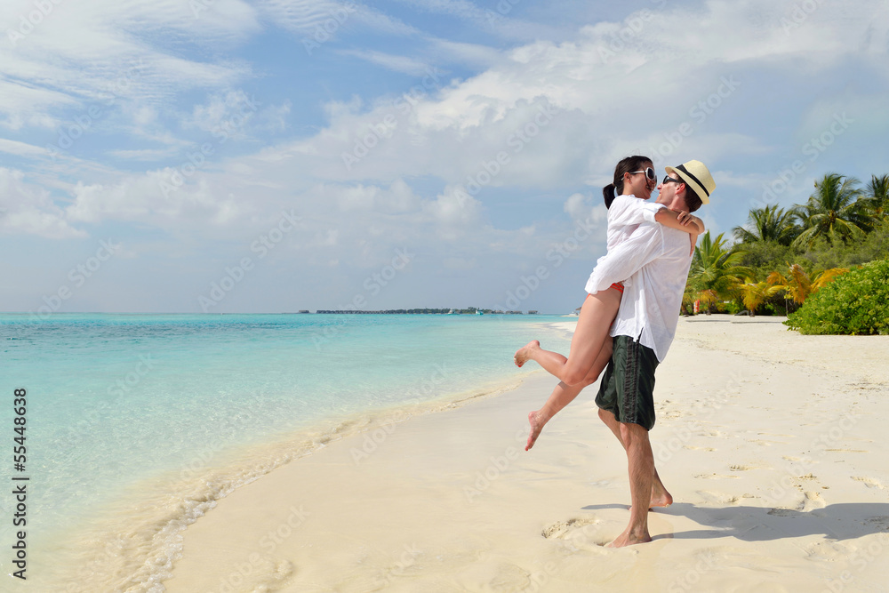 happy young couple have fun on beach