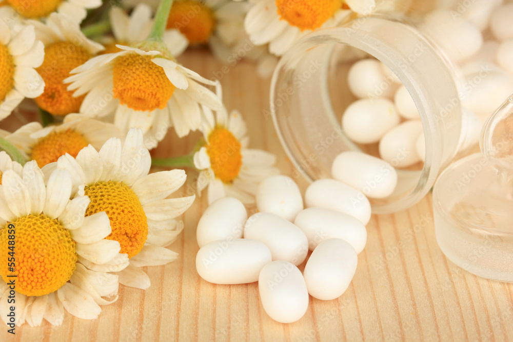 Medicine chamomile flowers on wooden table Medicine chamomile flowers on wooden table