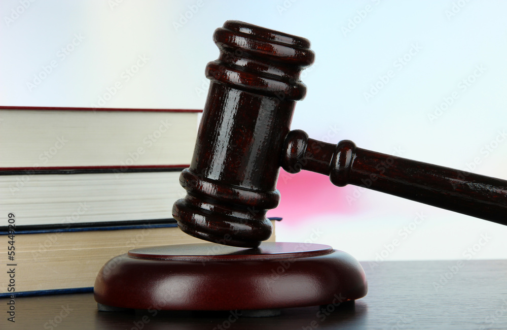 Gavel and books on table on light background Gavel and books on table on light background