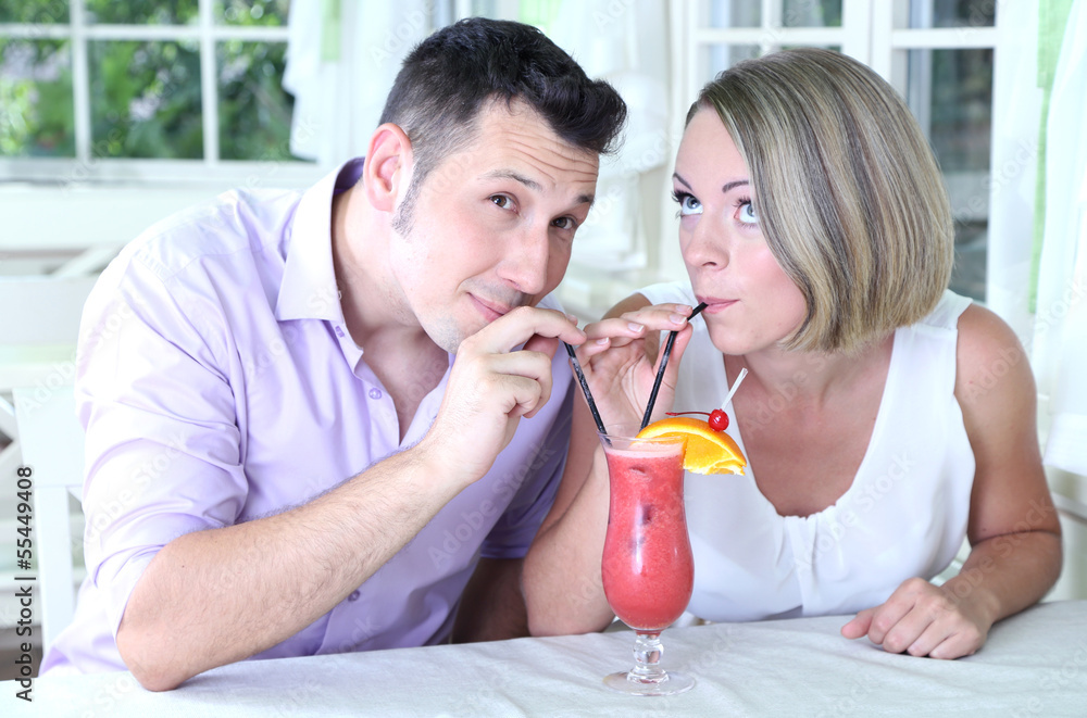 Beautiful couple drinking together cocktail at restaurant Beautiful couple drinking together cocktail at restaurant