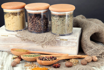 Fototapete Gewürze Assortment of spices in wooden spoons and glass jars,  © Africa Studio