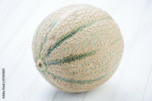 Cantaloupe melon over white wooden boards  studio shot