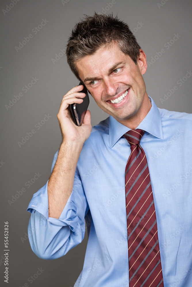 toothy smile businessman is talking on the phone toothy smile businessman is talking on the phone