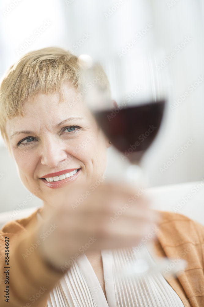 Smiling Woman Holding Up Red Wineglass Smiling Woman Holding Up Red Wineglass