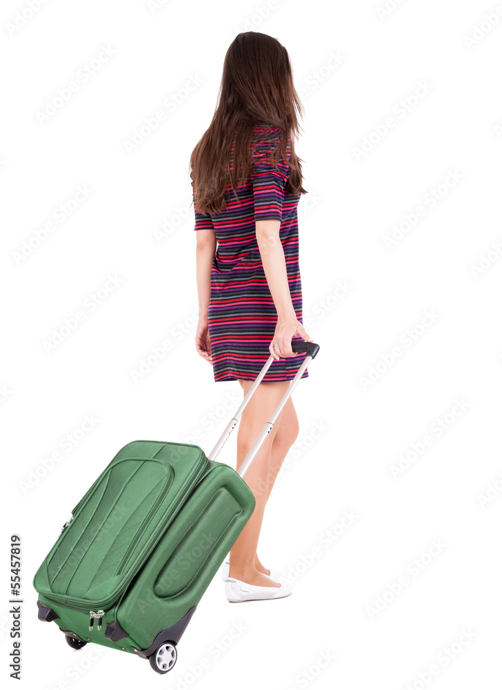 back view of walking woman with green suitcase back view of walking woman with green suitcase