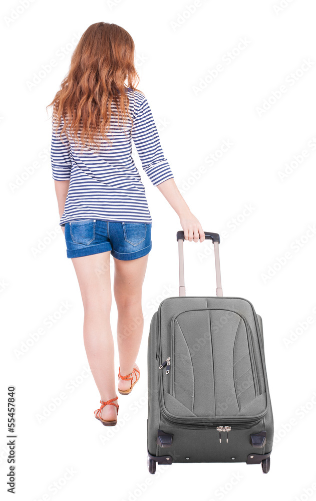 back view of walking woman with suitcase back view of walking woman with suitcase