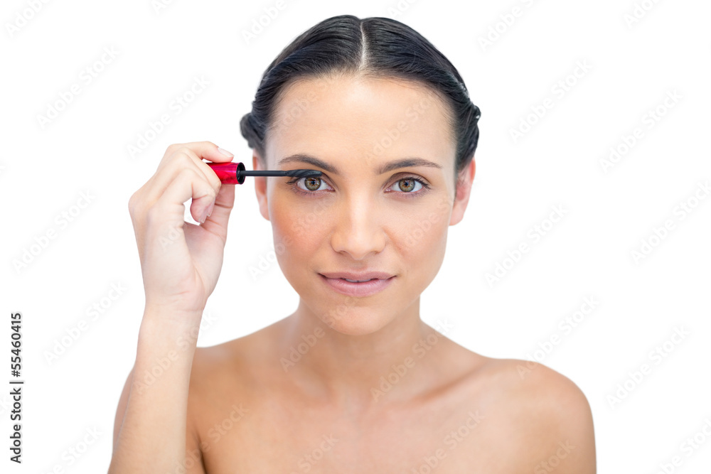 Young brunette applying mascara Young brunette applying mascara