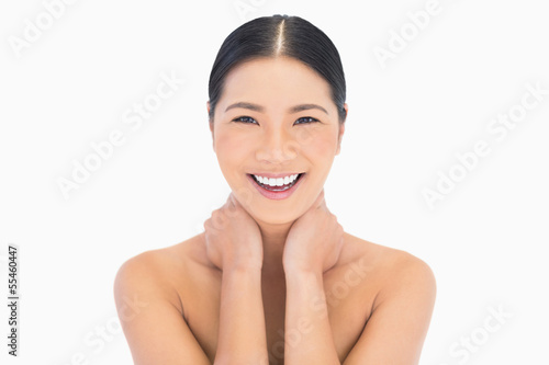 Cheerful natural model posing touching her neck