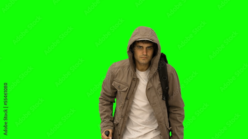 handsome man with a coat trekking on green screen handsome man with a coat trekking on green screen