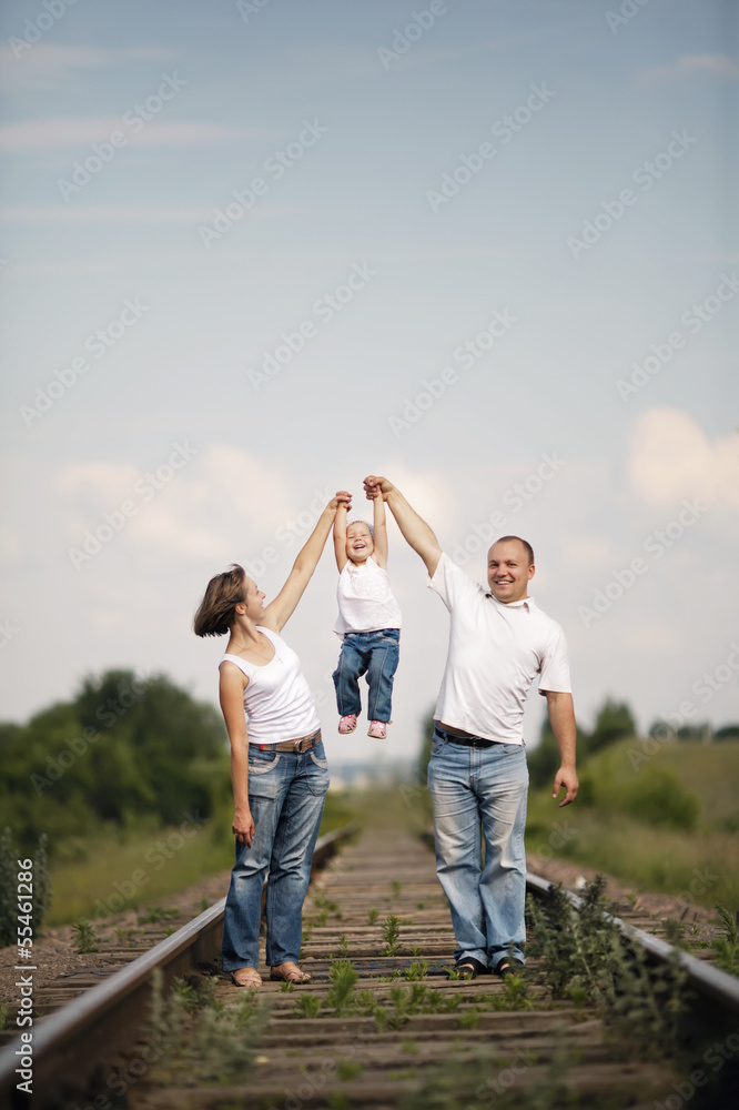 happy parents with baby on railroad happy parents with baby on railroad
