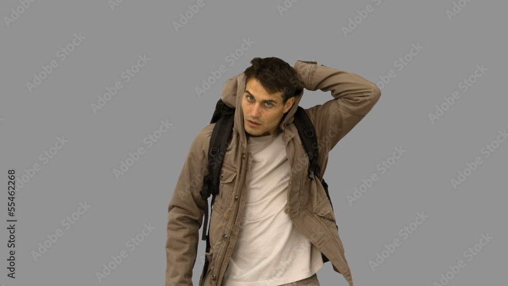 Handsome man walking towards the camera on grey screen Handsome man walking towards the camera on grey screen
