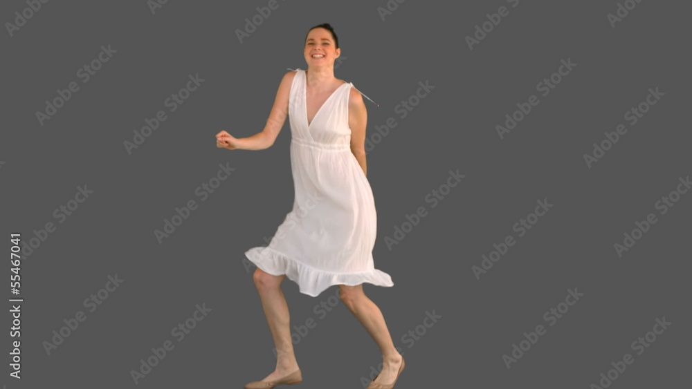 Elegant young woman in white dress dancing Elegant young woman in white dress dancing