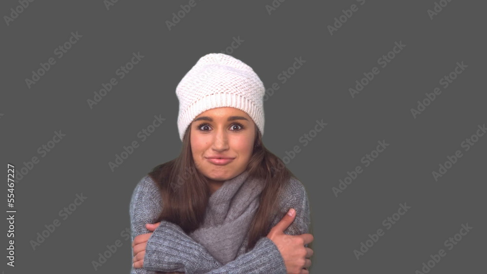 Smiling young model in winter clothes shivering Smiling young model in winter clothes shivering