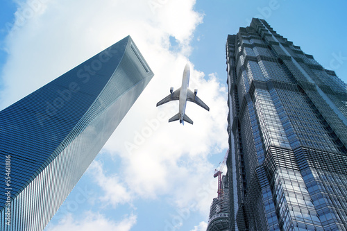 Canvas Print Modern buildings with airplane.